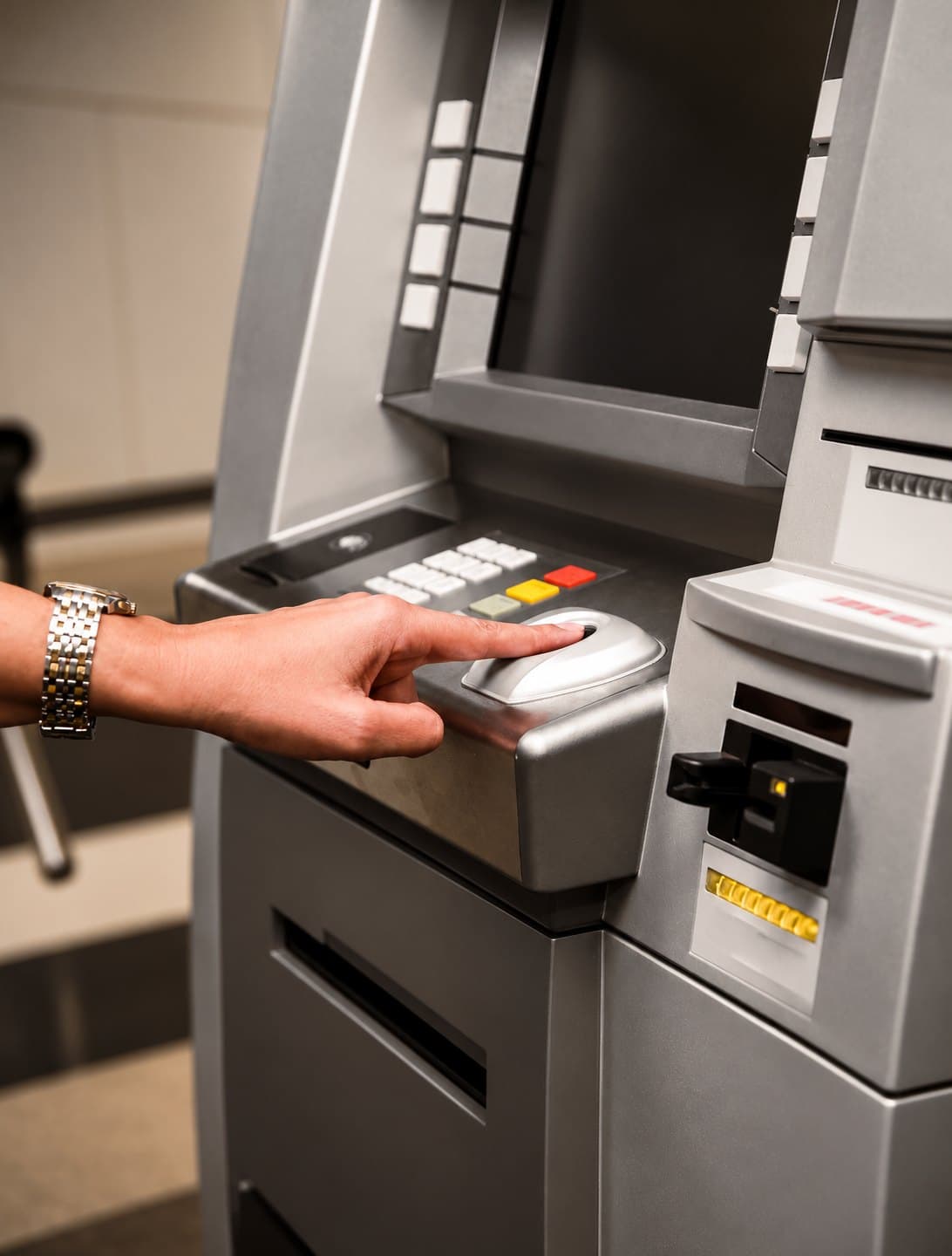 Finger on the biometric reader of a bank self-service terminal